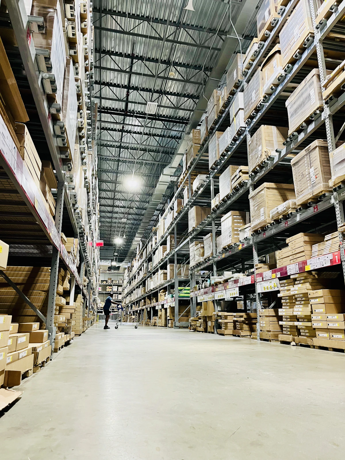 Tall warehouse shelves filled with cardboard boxes